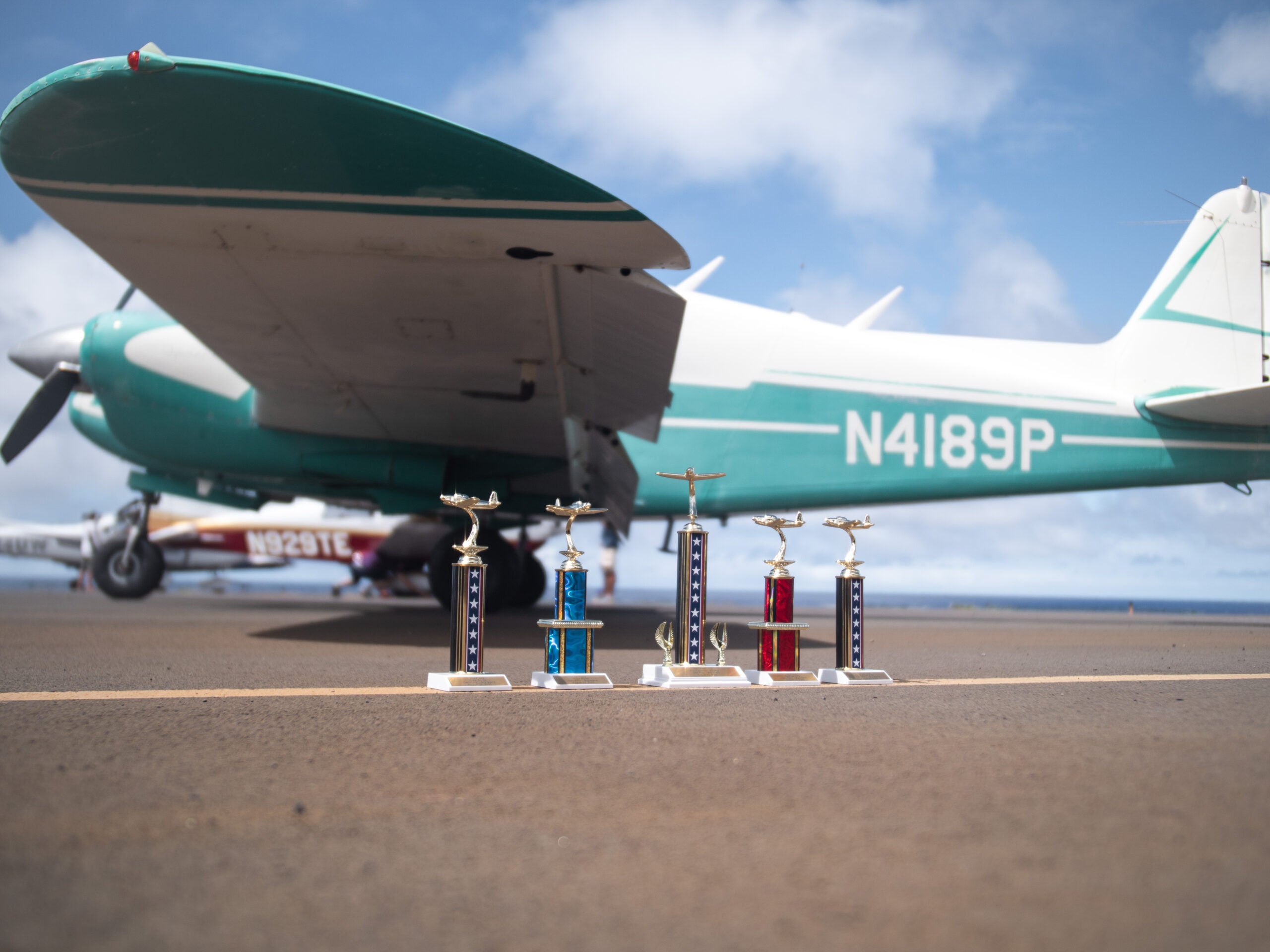 trophies in front of airplane