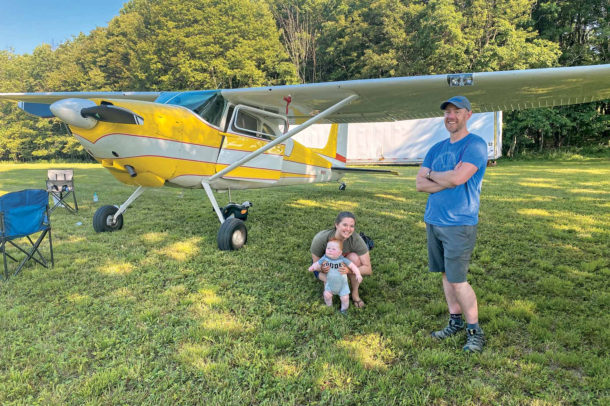 A family standing next to their airplane