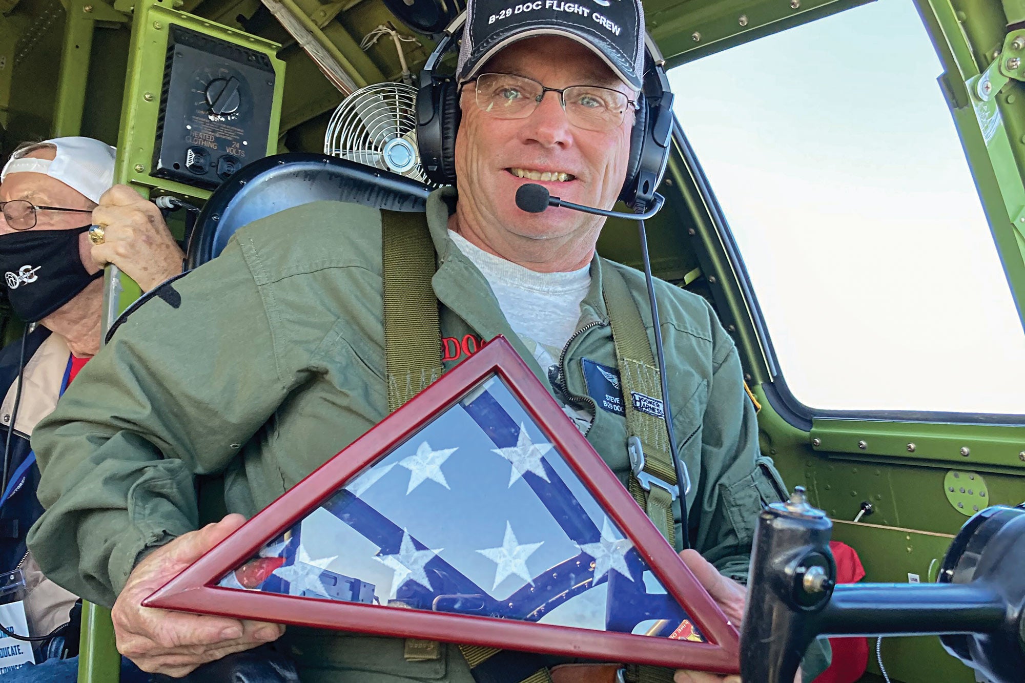 Aircraft pilot holding an American flag