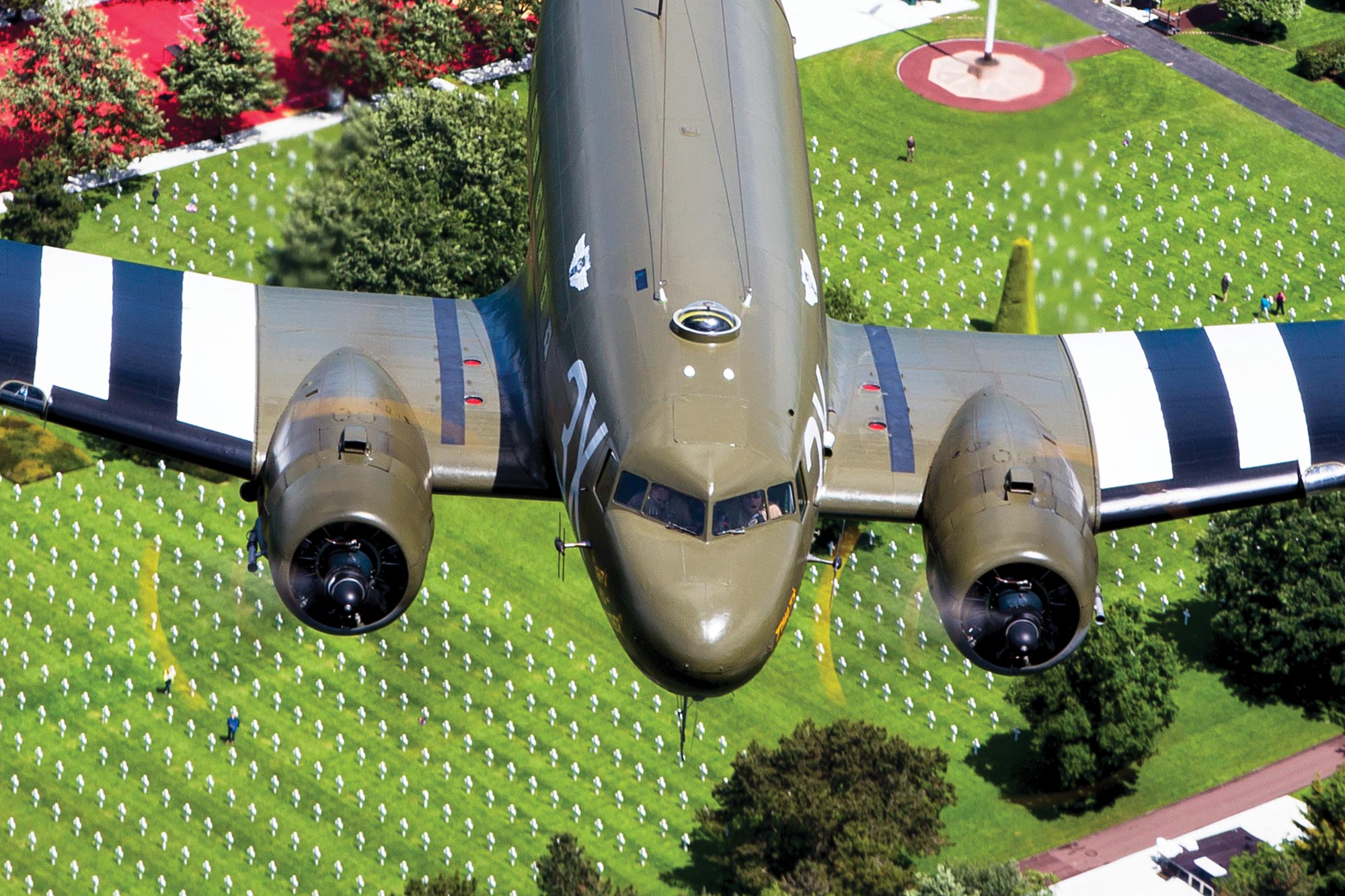 Airplane flies over cemeteries in Normandy