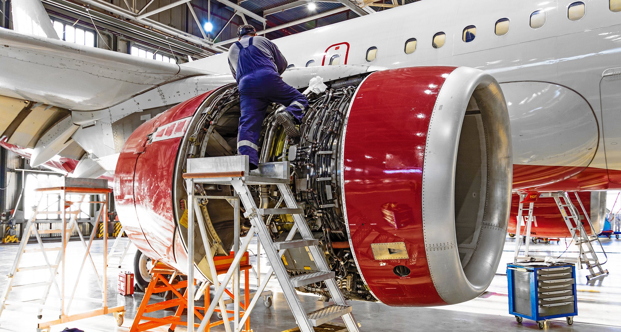 mechanic repairs aircraft engine jet