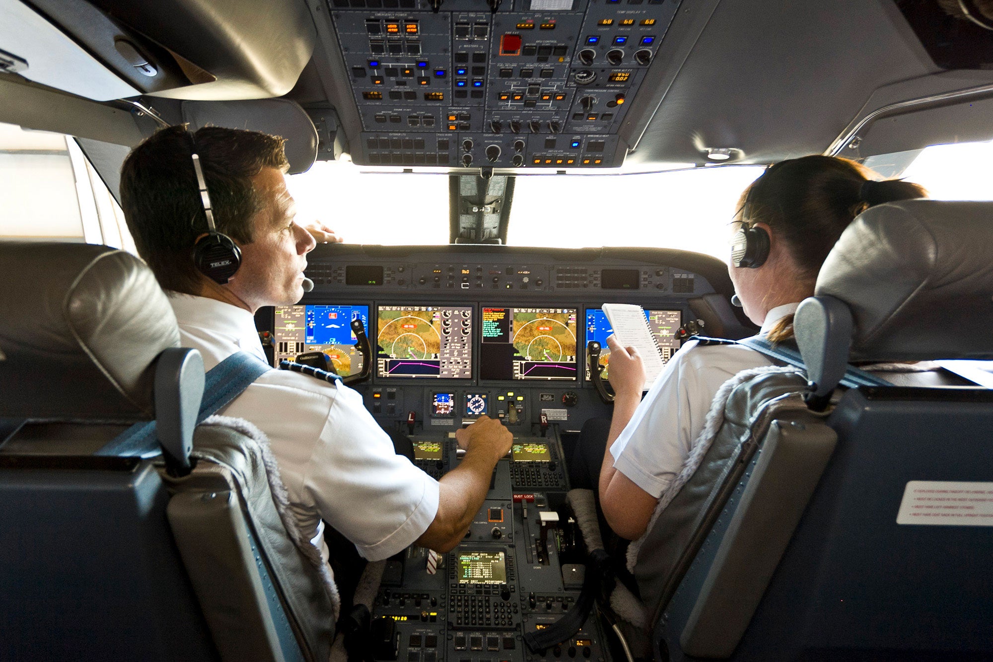 Airline pilots flying an airplane.