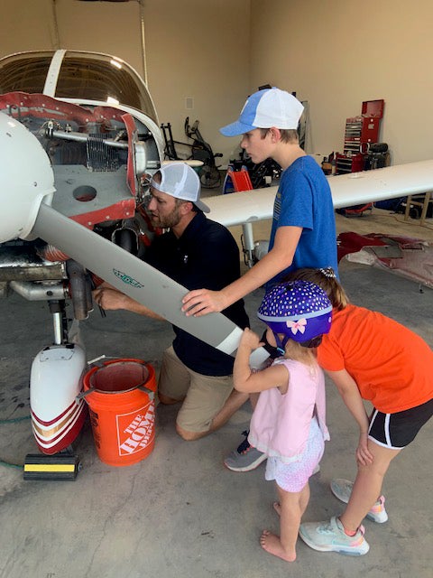 Stewart Pearcy gets some help with the upkeep of one of his family's airplanes.