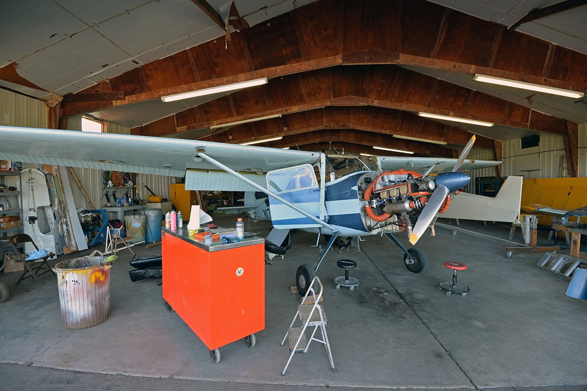 Single engine airplane undergoing an inspection in a hangar