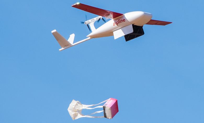 Airborne Zipline drone drops package with parachute