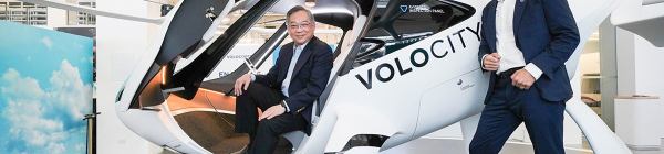 Singapore and Volocopter officials pose in a VoloCity prototype eVTOL air taxi