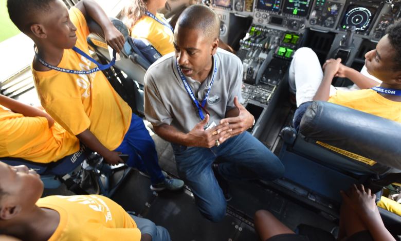 C-17 pilot Andrew Pierce gives students a tour of the C-17 flight deck