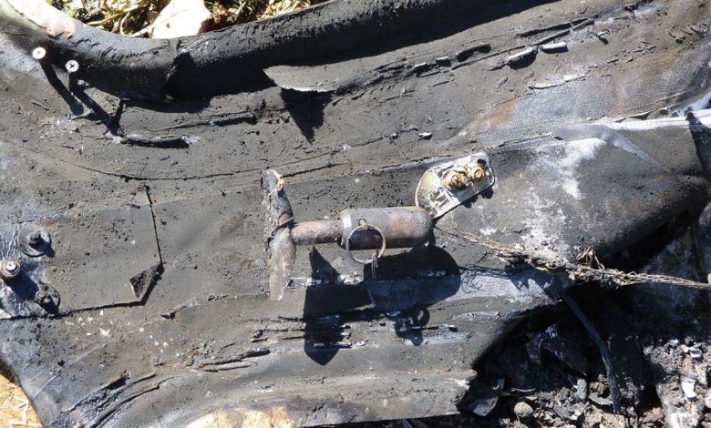 The wreckage of a Cirrus SR22 shows the CAPS handle and safety pin still intact.