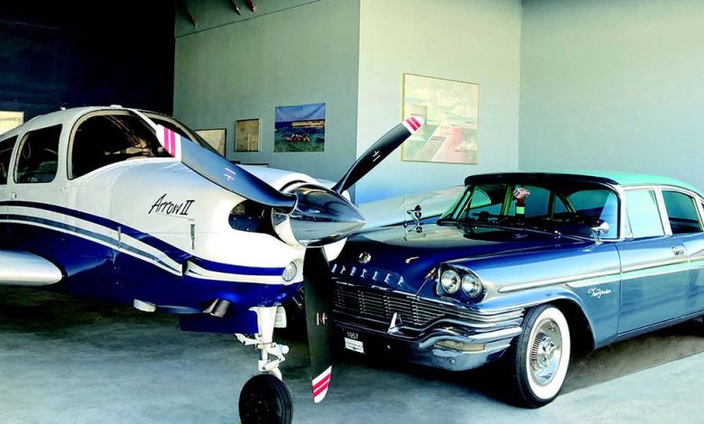A Piper and a Chrysler sitting next to each other in a hangar