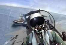 A Naval jet leaves the deck of an aircraft carrier. [Credit: Shutterstock]