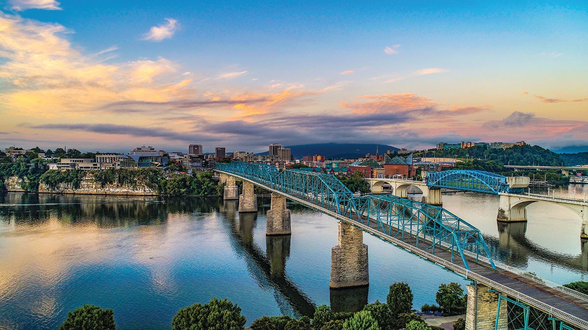 A view of the Tennessee River flowing under the well-known pedestrian bridge in downtown Chattanooga, Tennessee.