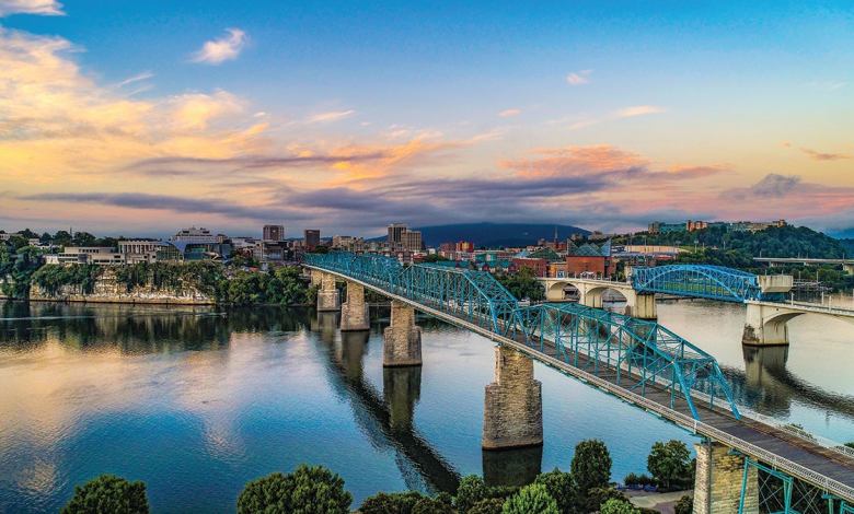 A view of the Tennessee River flowing under the well-known pedestrian bridge in downtown Chattanooga, Tennessee.