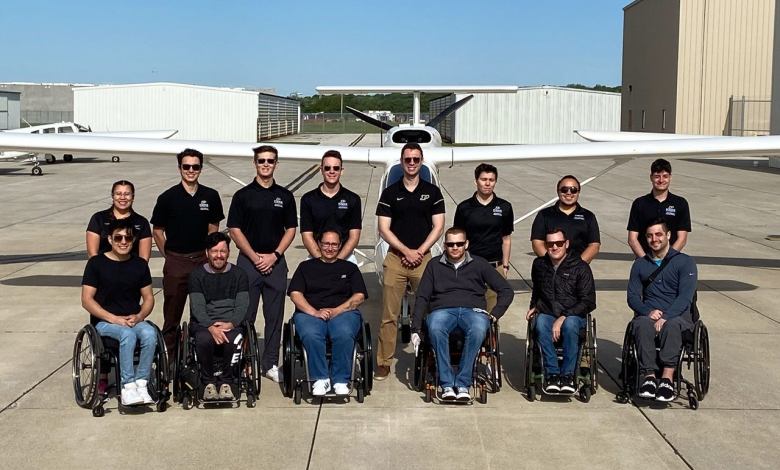 Nathaniel Miller, with Able Flight graduates, class of 2022