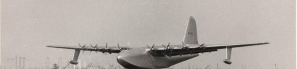 An historic image of the aircraft that would become known as the Spruce Goose, as it starts to lift off the water for its one and only flight.
