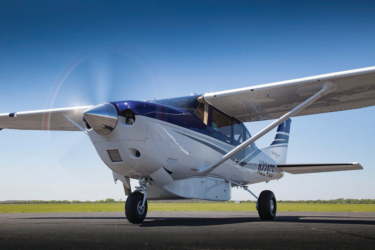 A Cessna Turbo Stationair with its prop turning on the tarmac.