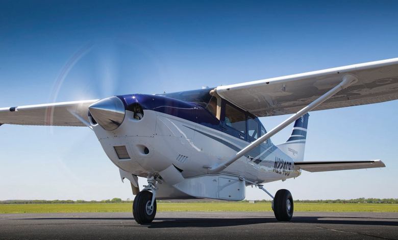 A Cessna Turbo Stationair with its prop turning on the tarmac.