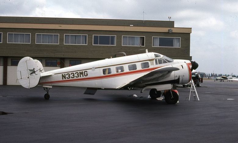 A Beechcraft Super 18 on the tarmac at an airport.