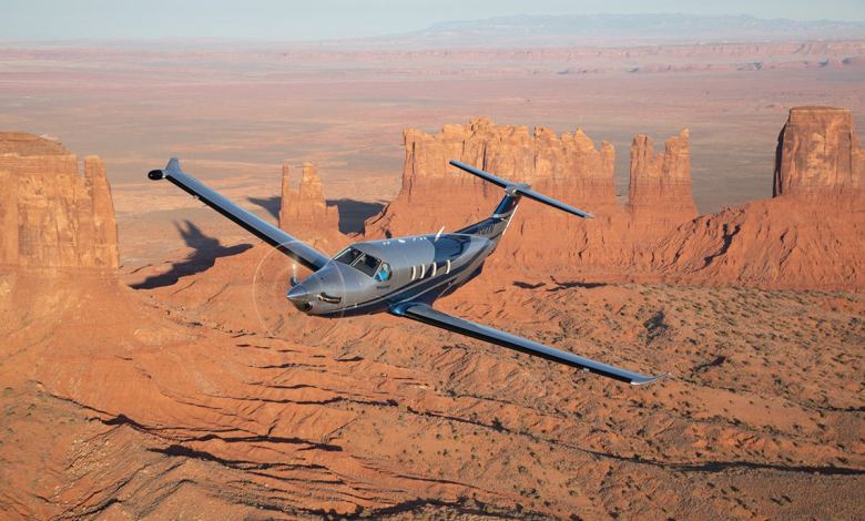 The Pilatus PC-12 aircraft soars over Monument Valley.
