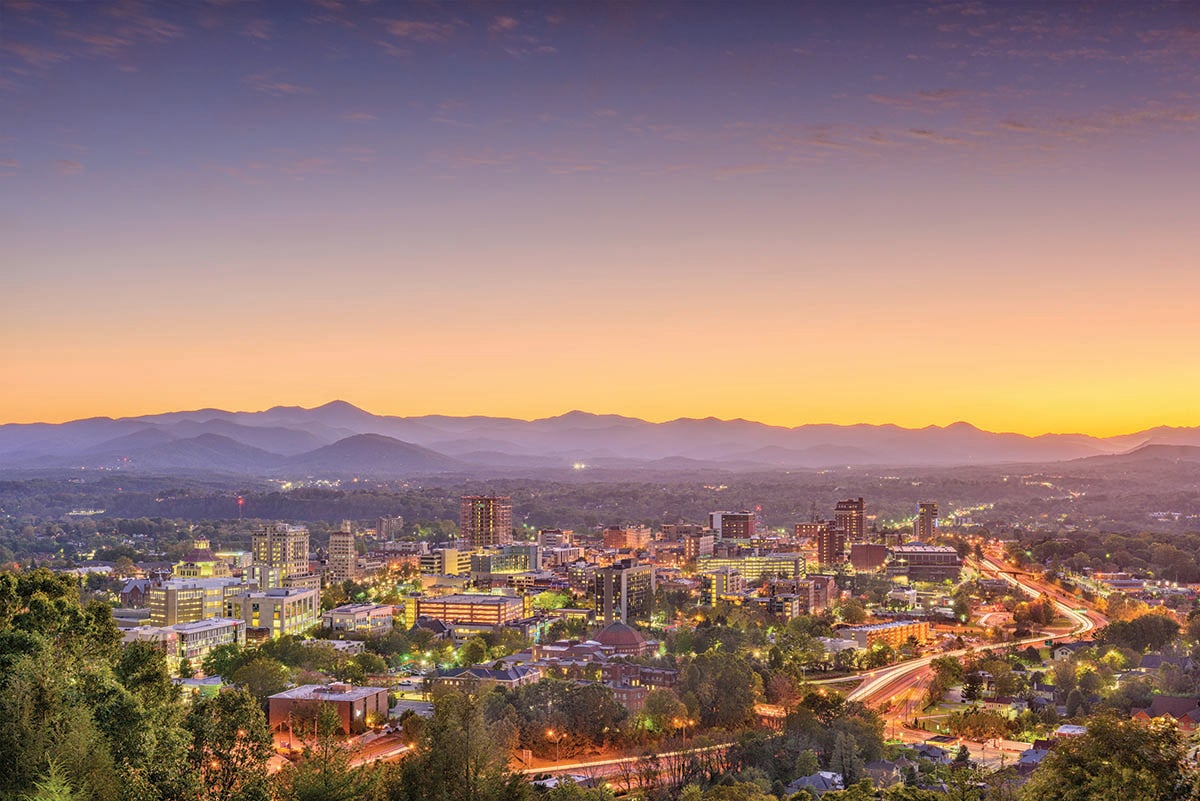 The city of Asheville, N.C., and the Blue Ridge mountains in the distance at sunset