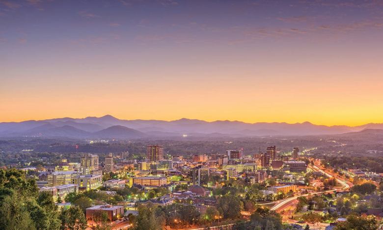 The city of Asheville, N.C., and the Blue Ridge mountains in the distance at sunset