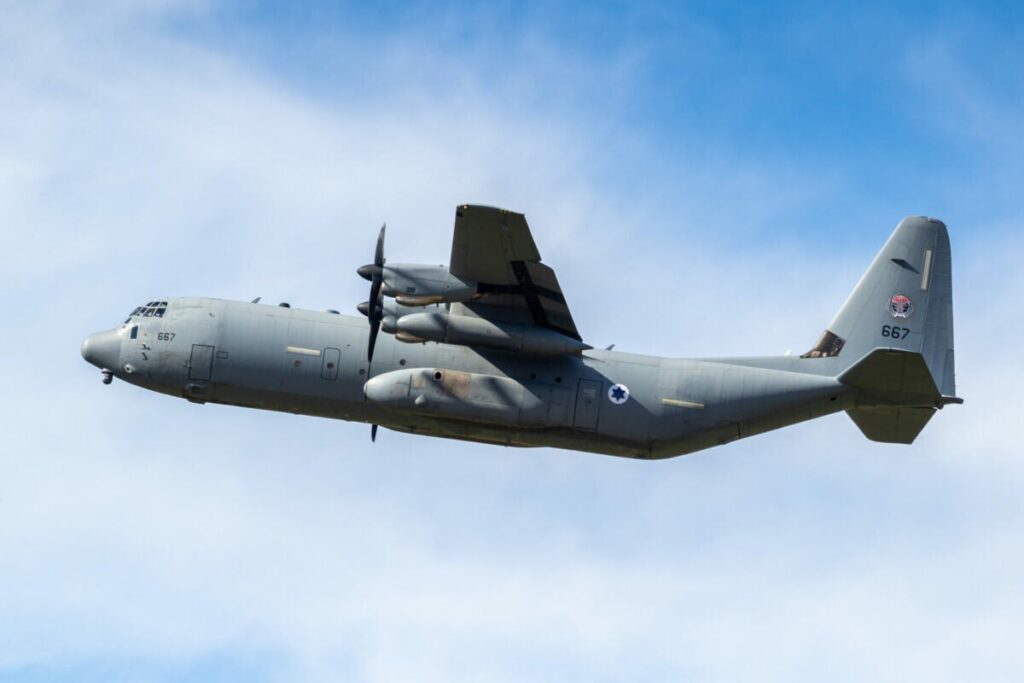 A Lockheed C-130 Hercules military transport airplane in flight.