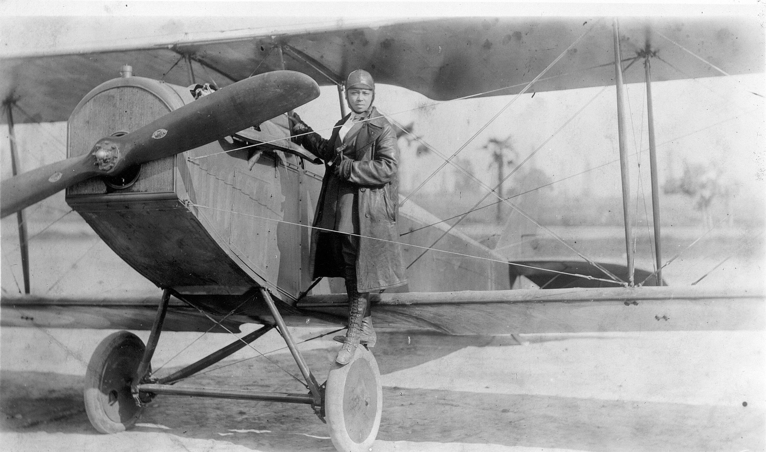 Bessie Coleman stands with her aircraft in 1922.