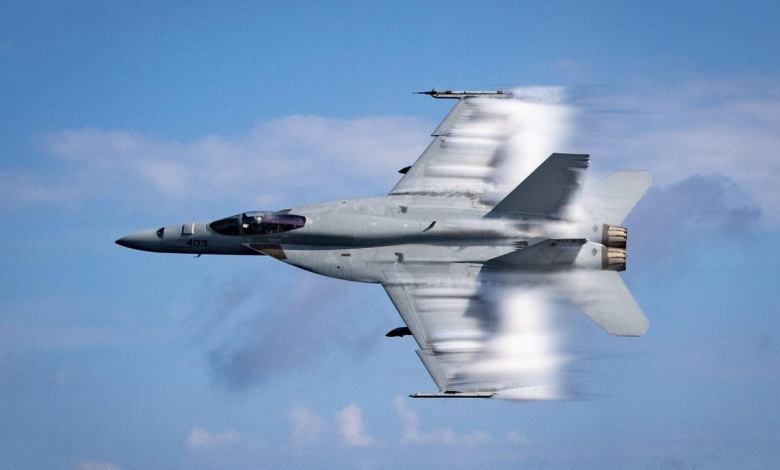 U.S. Navy Lieutenant Commander Benjamin Orloff conducts a supersonic pass in an F/A-18E Super Hornet during a training exercise over the Atlantic Ocean.