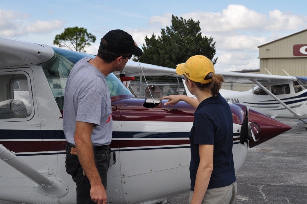 An instructor and a student preflight a Cessna 152 before a lesson. [Credit: Richard Steiger]