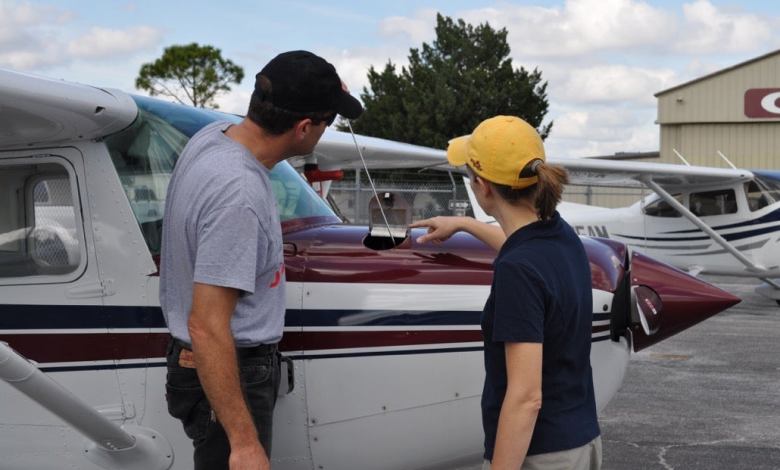 An instructor and a student preflight a Cessna 152 before a lesson. [Credit: Richard Steiger]