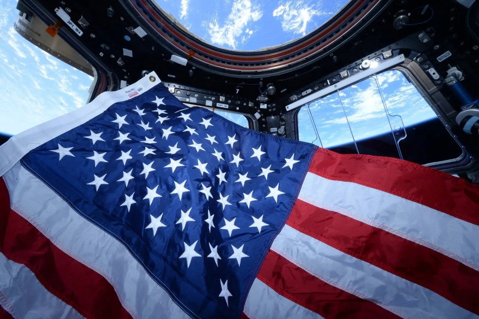 ISS astronauts U.S. flag