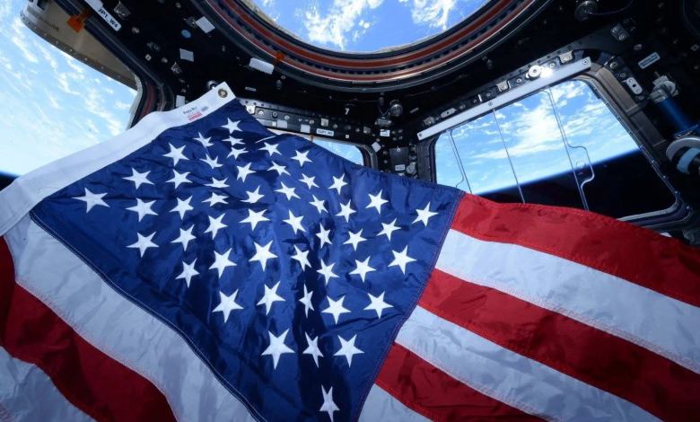 ISS astronauts U.S. flag