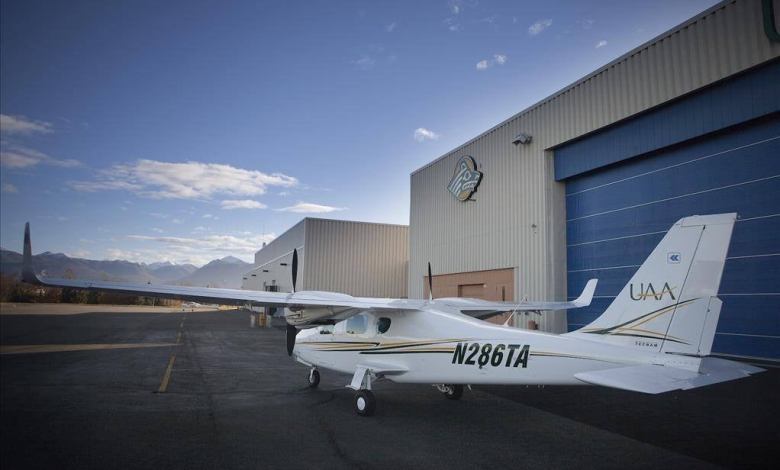 Small plane outside hangar.