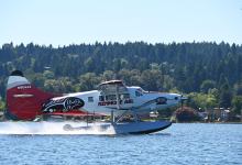 One of Kenmore Air’s seaplanes is wrapped in the Puyallup Tribe’s and Emerald Queen Casino’s colors and salmon. [Courtesy: Kenmore Air]