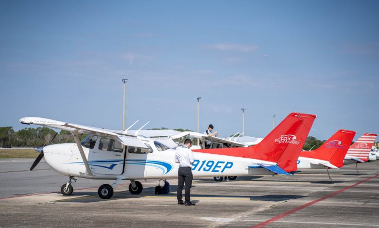 a piston aircraft sits on an airport ramp