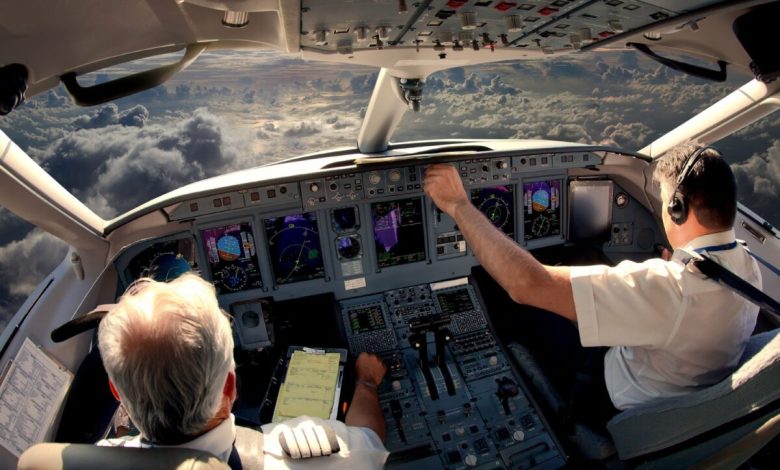 Pilots in an aircraft cockpit.