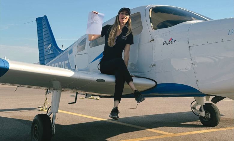 Pilot on wing of aircraft