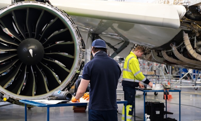 Technicians work on engine