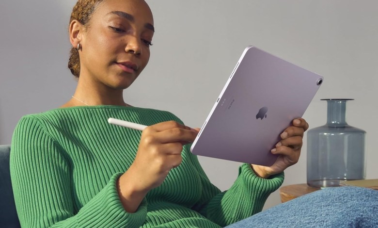 Woman holding an Apple tablet