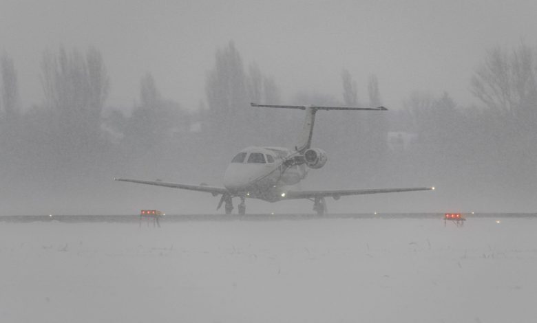An Embraer EMB-500 Phenom 100 taxis at London Southend Airport, which is covered in snow during blizzard. [Alamy]