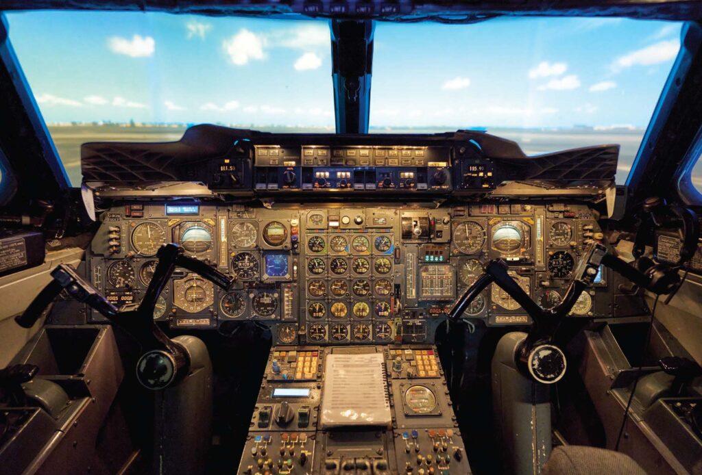 Panel lights bathe the flight simulator in a warm, subdued glow. [Credit: Jeff Berlin]