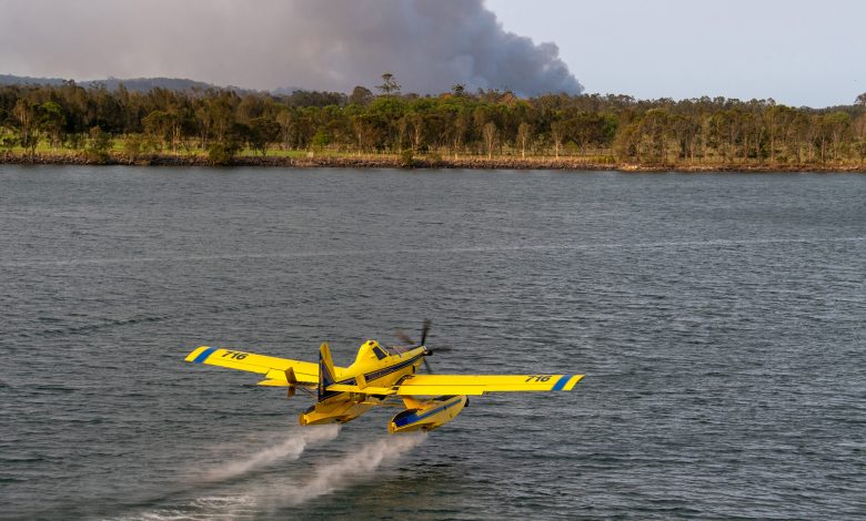 A Fire Boss aircraft scooping while fighting brush fires in Australia.