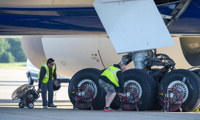 Boeing workers position fans to cool the 777X's wheels and brakes after testing. [Credit: Boeing/Paul Weatherman]