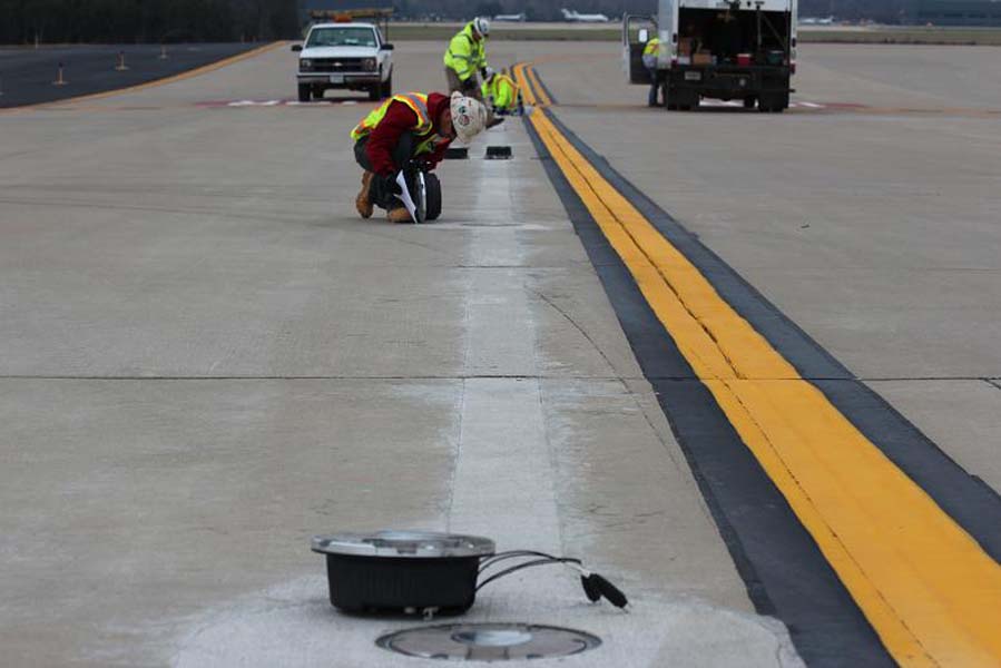 Workers installing a Runway Status Lights system. [Credit: U.S. Department of Transportation]
