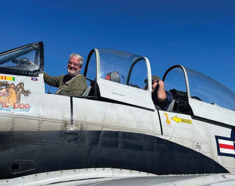 Alex Munro sits in the front seat of a T-28C with airshow pilot-instructor Chris Rounds as they prepare to depart Peachtree Airport in Georgia on a training flight.
