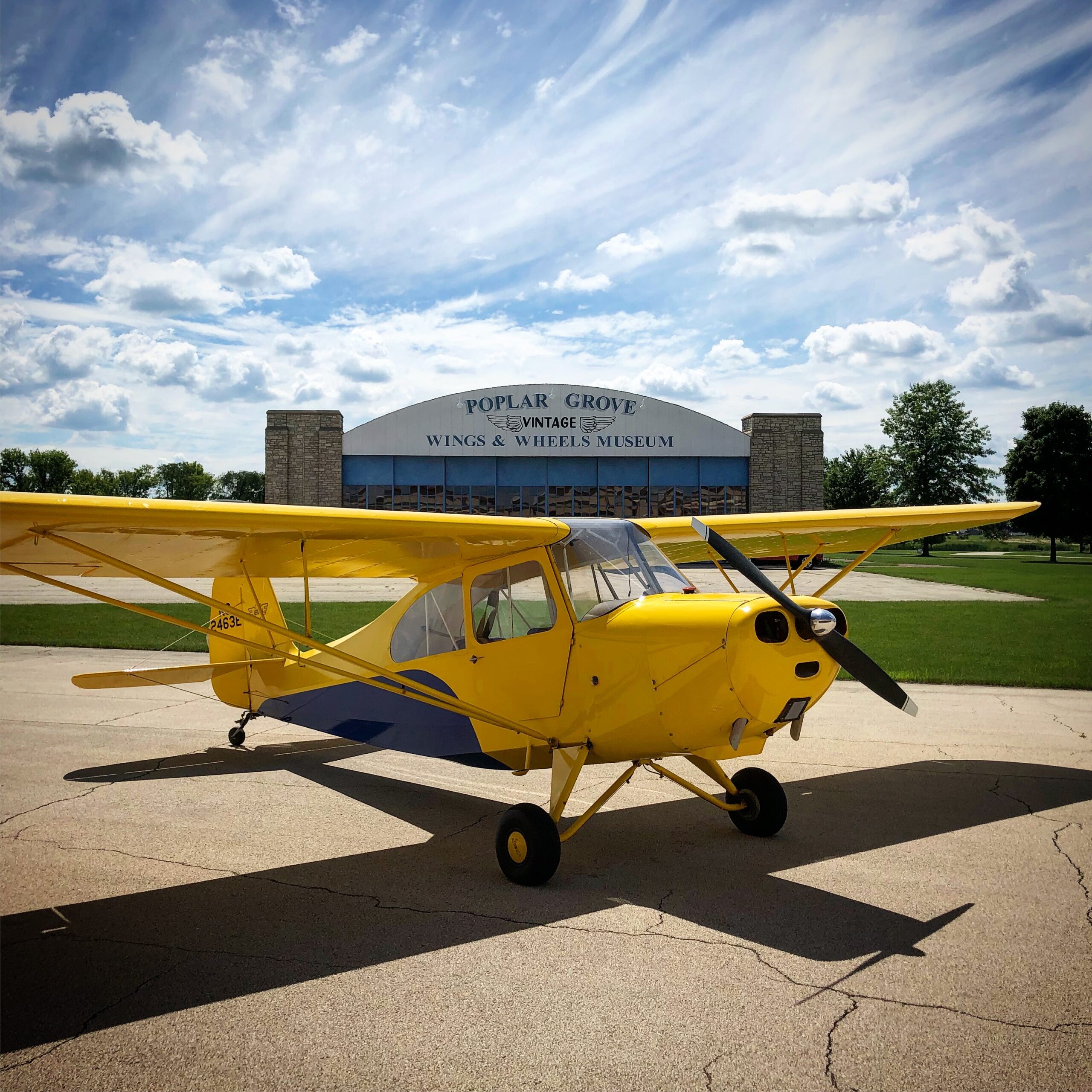 Yellow vintage airplane at Poplar Grove Wings & Wheels Museum.