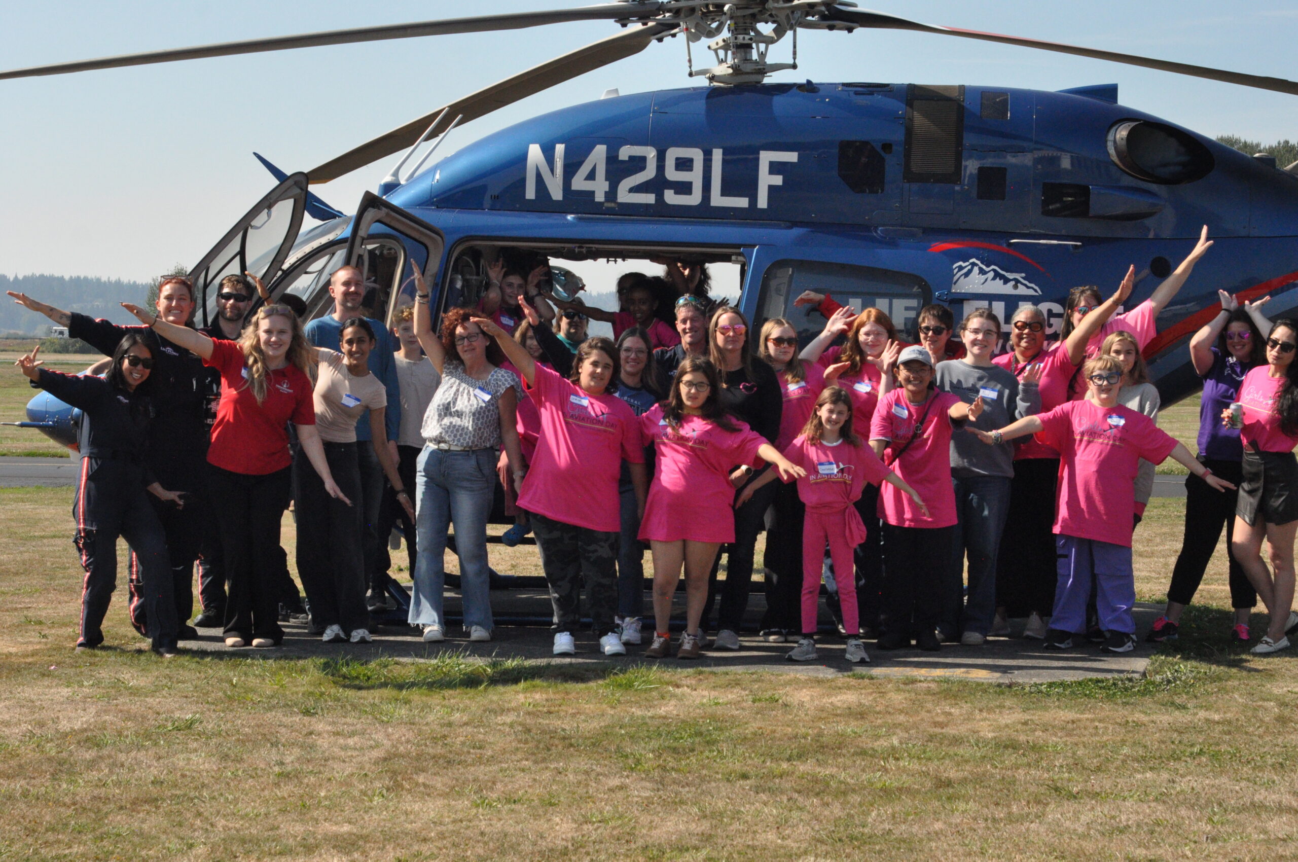 Participants in the 11th annual Girls in Aviation Day at Harvey Field Airport (S43) in Snohomish, Washington, pose with a LifeFlight helicopter. [Courtesy: Cailee Landis]