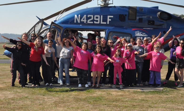 Participants in the 11th annual Girls in Aviation Day at Harvey Field Airport (S43) in Snohomish, Washington, pose with a LifeFlight helicopter. [Courtesy: Cailee Landis]