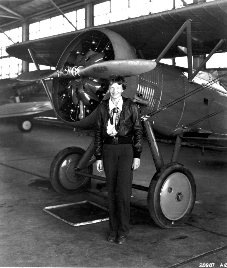 In this photo taken in 1935, Amelia Earhart stands in front of a Boeing P-12 at March Field in California. [Credit: National Archives]