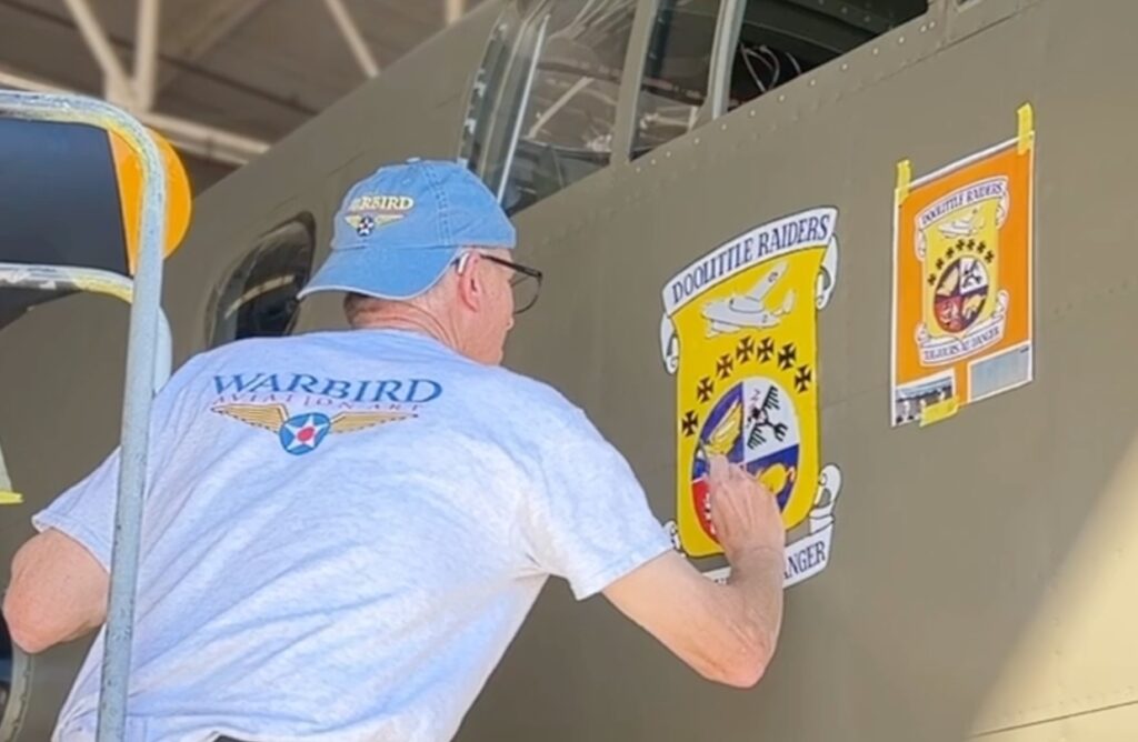 Ron Kaplan works on the main crest on a restored B-25 in honor of the famous Doolittle Raiders of World War II. [Courtesy: Rob Kaplan]