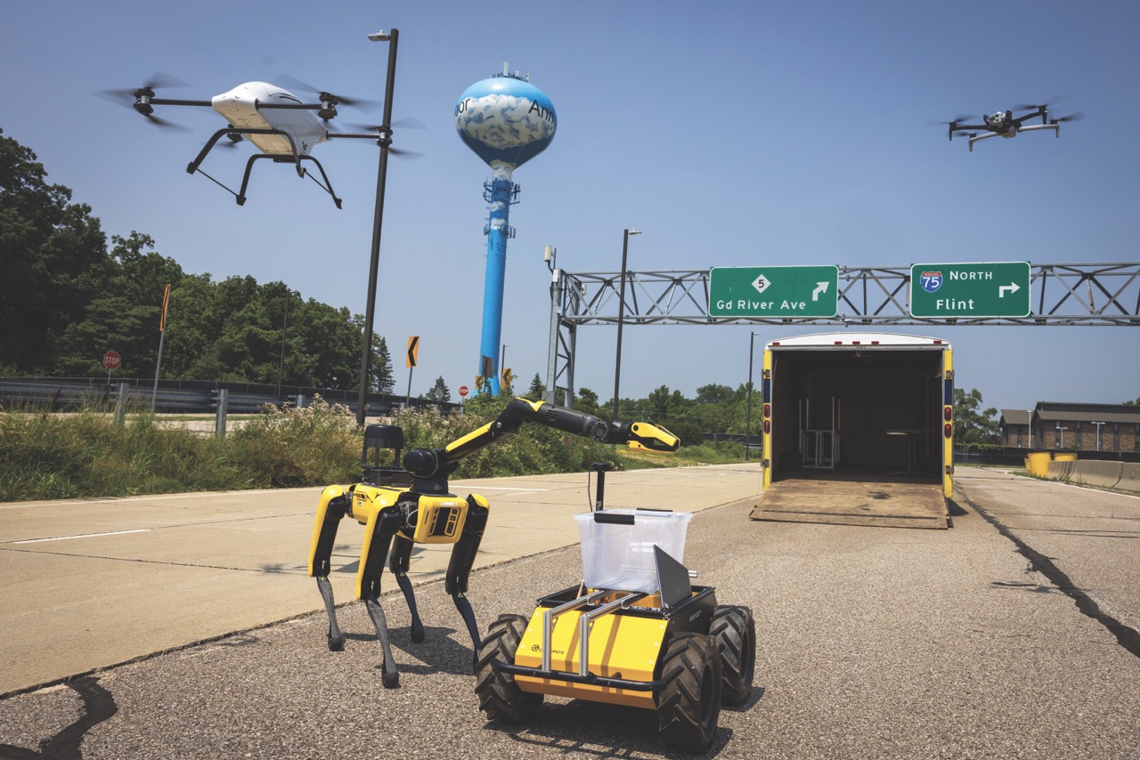 Drones fly above ground robots at the University of Michigan’s autonomous vehicle testbed site that is expanding to include electric and uncrewed aerial vehicles. [Szczepanski/Michigan Engineering]